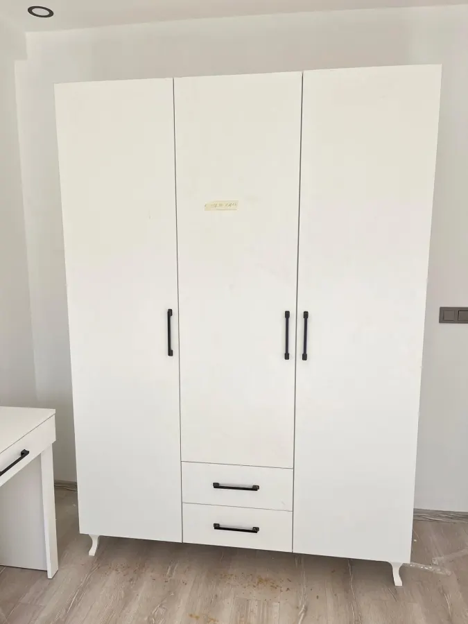 Beyaz, iki kapılı ve alt çekmeceli gardırop